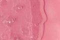 Textured backdrop with air bubbles. Gel, serum or hyaluronic acid on light pink background Royalty Free Stock Photo