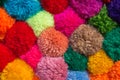 Textured background of assorted and multicolored wool pom poms Royalty Free Stock Photo