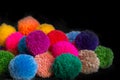Textured background of assorted and multicolored wool pom poms Royalty Free Stock Photo
