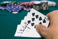 A close up image of stacked poker chips and a royal flush. A textured background.Copy paste place Royalty Free Stock Photo