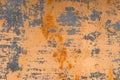 Textured background of a faded yellow paint with rusted cracks on rusted metal. Grunge texture of an old cracked metal Royalty Free Stock Photo