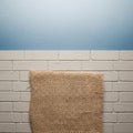 A textured background featuring a white brick wall below a light blue wall, creating a two-tone Royalty Free Stock Photo