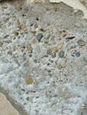 Textured background with grey concrete (stone) wall and pebbles Royalty Free Stock Photo