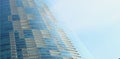 Textured background of modern glass building skyscrapers over blue cloudy sky Royalty Free Stock Photo