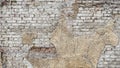 Textured background of an old, weathered brick wall with patches of rough, crumbling plaster Royalty Free Stock Photo