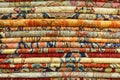 Textured background of a stack of oriental rugs