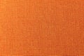 Textured background surface of textile upholstery furniture close-up. Orange color fabric structure Royalty Free Stock Photo