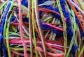 textured background of a tangle of multicolored yarn threads of different colors and thicknesses