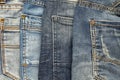 Textured background of a variety of denim pants in various shades of blue stacked rows of back pockets up Royalty Free Stock Photo