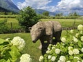 Bear Sculpture Amidst Blooming Flowers at FiavÃ© Archeo Natura Park Royalty Free Stock Photo