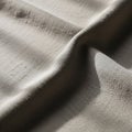 Textured beige fabric with visible woven pattern, cast in soft light. The surface shows Royalty Free Stock Photo