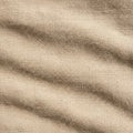 Textured beige fabric with a woven pattern. The surface shows subtle, natural-looking Royalty Free Stock Photo