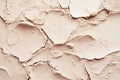 Textured beige surface with uneven edges and a powdery appearance against a softly blurred background in a minimalistic