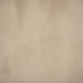 A textured beige wall, displaying subtle variations in color and small spec Royalty Free Stock Photo