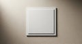 A textured beige wall features a centrally placed, empty white square frame. The Royalty Free Stock Photo