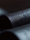 Textured Black Material: A close-up view showcasing the intricate pattern of a dark, subtly reflective, fabric-like surface. Royalty Free Stock Photo