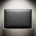A textured black rectangular object with a silver border and ribbed edges isolated on white background Royalty Free Stock Photo