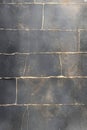 Textured black stone wall with visible cracks and lines showcasing natural elements Royalty Free Stock Photo