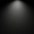 A textured black surface is illuminated by a subtle overhead spotlight, cre Royalty Free Stock Photo