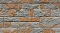 Textured brick wall with orange and grey stone blocks Royalty Free Stock Photo