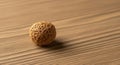 Textured Brown Ball on Wooden Surface with Warm Lighting Royalty Free Stock Photo