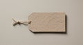 A textured, brown paper tag with a rectangular shape and angled corners lies on a Royalty Free Stock Photo
