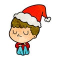 textured cartoon of a grumpy boy wearing santa hat