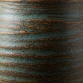 Textured ceramic surface featuring a blend of earthy brown and muted blue-green Royalty Free Stock Photo