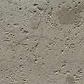 Textured concrete surface featuring circular etchings and scattered depressions. The Royalty Free Stock Photo