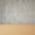 A textured concrete wall with small pockmarks and a smooth, brown, horizontal surfac Royalty Free Stock Photo