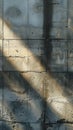 Textured concrete wall with sunlight and shadows, abstract urban background concept Royalty Free Stock Photo