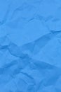 Textured crumpled blue paper background. Copyspace