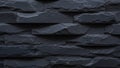 Textured dark grey slate stone wall with rough stacked rectangular blocks and visible chisel marks Keywords: stone Royalty Free Stock Photo