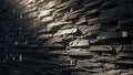 Textured dark grey stacked stone wall with light shining on particles Keywords: stone, wall, texture, stacked, grey Royalty Free Stock Photo