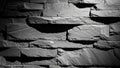 Textured dark grey stone wall with dramatic lighting and deep shadows creating a rugged surface Keywords: stone wall Royalty Free Stock Photo