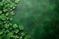 Textured deep green background with clover leaves and copy space. Top view backdrop for St. Patrick\'s Day holiday