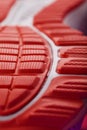 Textured design of the sole of the sport shoe in red Macro