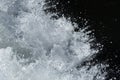 A textured and detailed close up macro photograph of water spray and drops