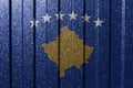 Textured flag of Kosovo on metal wall. Colorful natural abstract geometric background with lines