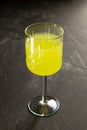 Textured glass with limoncello or poncha drink on a dark concrete surface Royalty Free Stock Photo