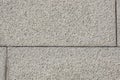 Textured gray granite wall with uniform rectangular blocks in daylight Royalty Free Stock Photo