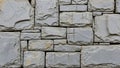 Textured grey stone wall constructed from rough hewn rectangular blocks with visible chisel marks and subtle color Royalty Free Stock Photo