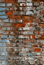 Textured grunge background. Old, ruined red brick wall with faded blue paint elements. Vertical photo Royalty Free Stock Photo