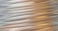 Textured metallic surface with smooth, flowing, rippling waves and reflections, abstract background Royalty Free Stock Photo