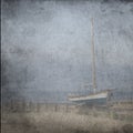 Textured old grange paper background with blue sail yacht