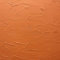 Textured orange wall with a plaster-like finish. The surface features irregular, wavy Royalty Free Stock Photo