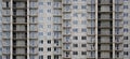 Textured pattern of a russian whitestone residential house building wall with many windows and balcony under constructio Royalty Free Stock Photo