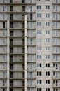 Textured pattern of a russian whitestone residential house building wall with many windows and balcony under constructio Royalty Free Stock Photo