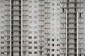 Textured pattern of a russian whitestone residential house building wall with many windows and balcony under construction Royalty Free Stock Photo