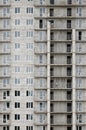 Textured pattern of a russian whitestone residential house building wall with many windows and balcony under construction Royalty Free Stock Photo